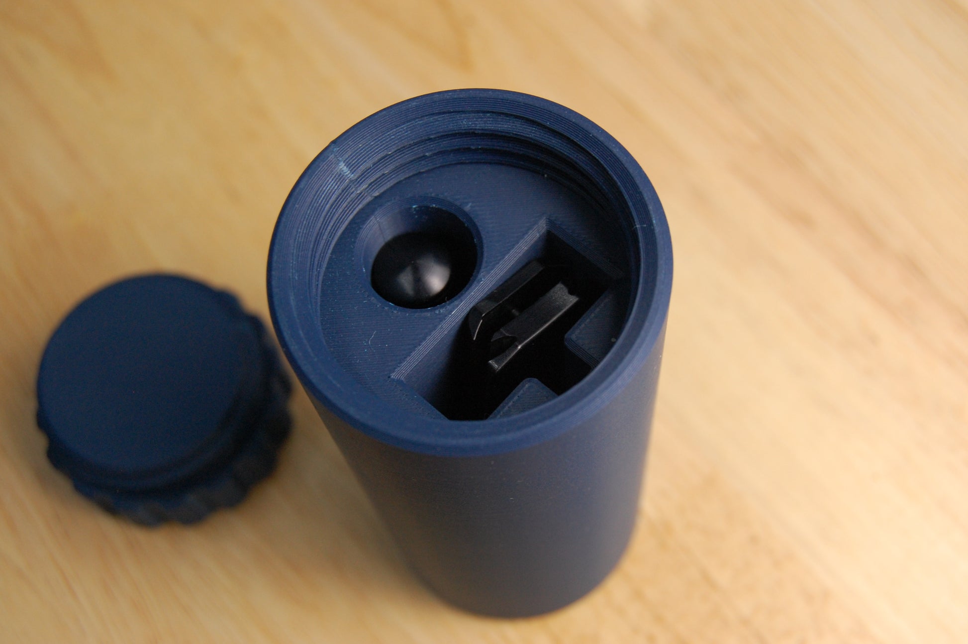 Closeup of navy blue capsule razor case.