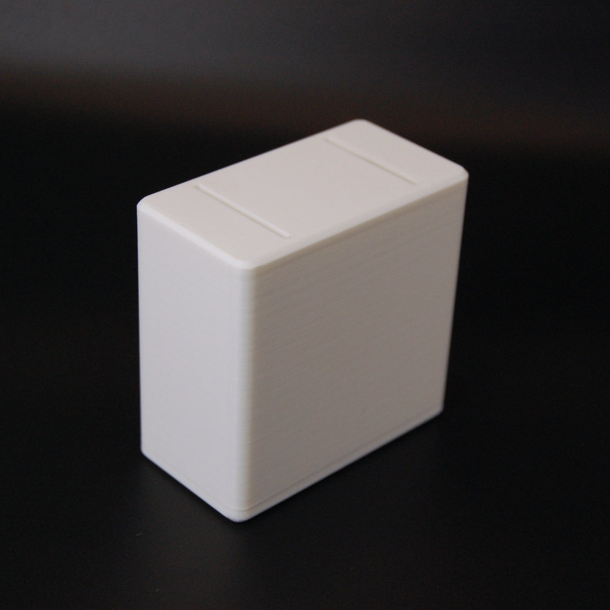 White rectangular 3D-printed razor blade bank with sliding lid, compact box shape with rounded edges