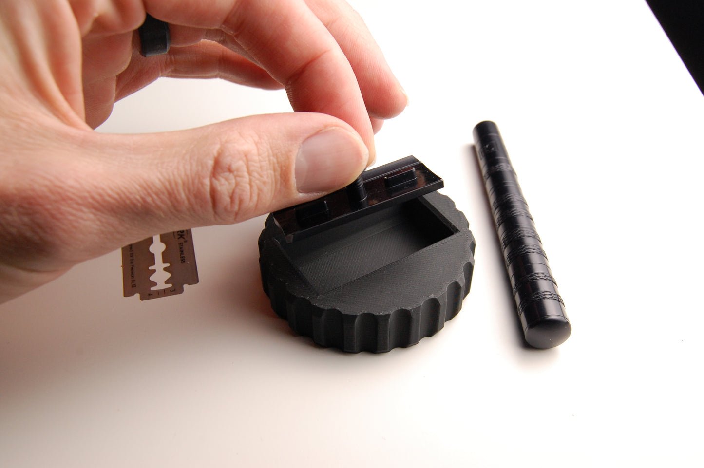 Close usage shot of the Henson Blade Installation and Removal Tool.  Installing the Henson razor head into the tool.