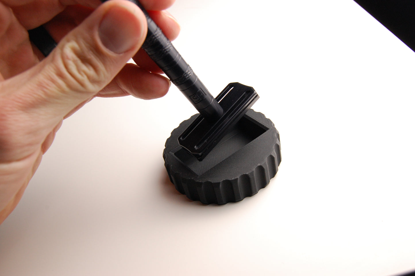 Assembled Henson Razor being removed from the Installation and Removal Tool.
