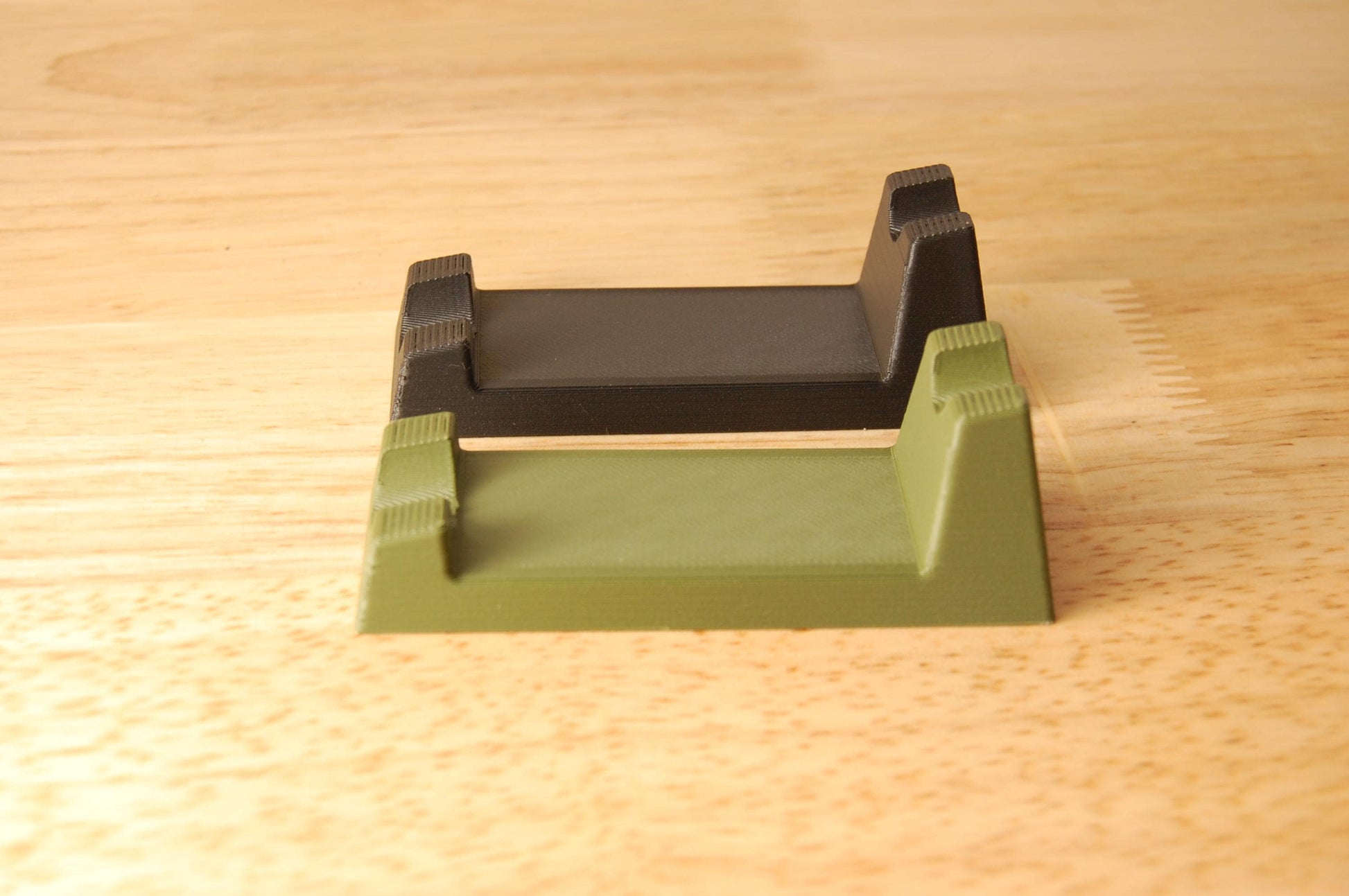 Henson Safety Razor Stands in Olive and Black, safety razor. The stand is on a wooden butcher block table.