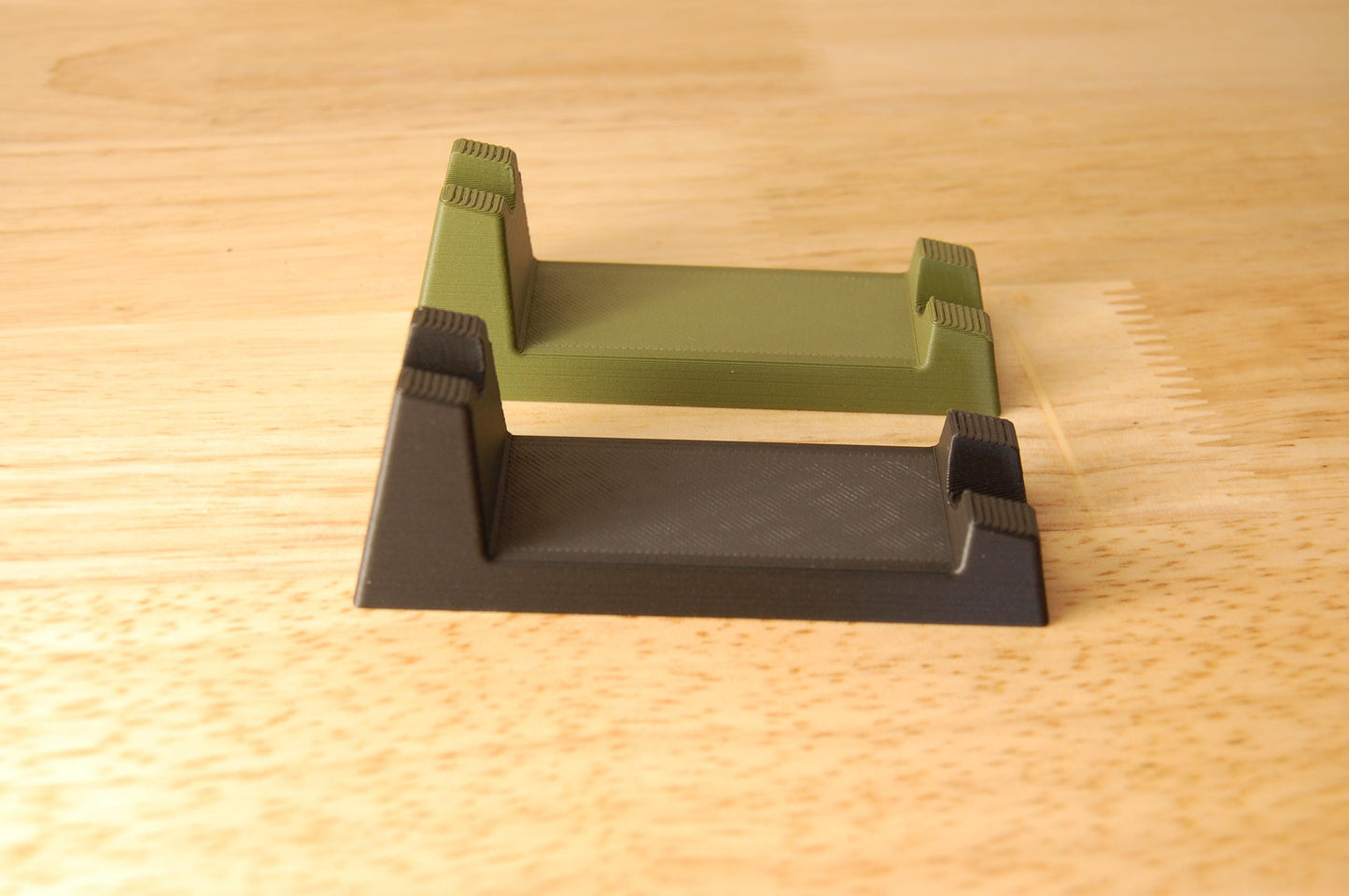 Henson Safety Razor Stands in Olive and Black, safety razor. The stand is on a wooden butcher block table.