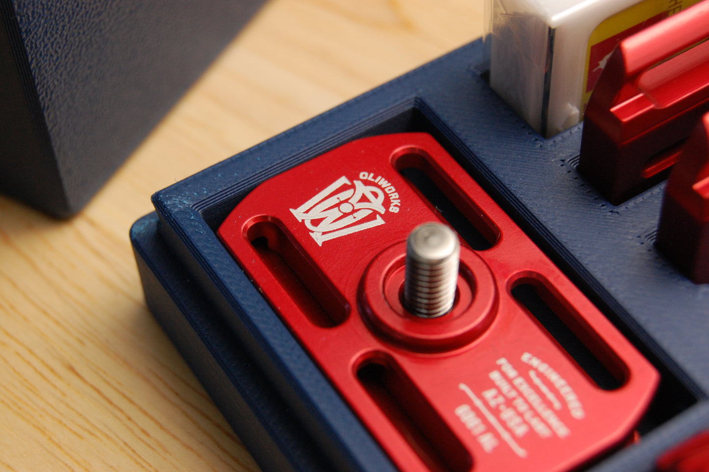 Close up of a Red Oliworks M3teorite in a Navy Blue travel case.
