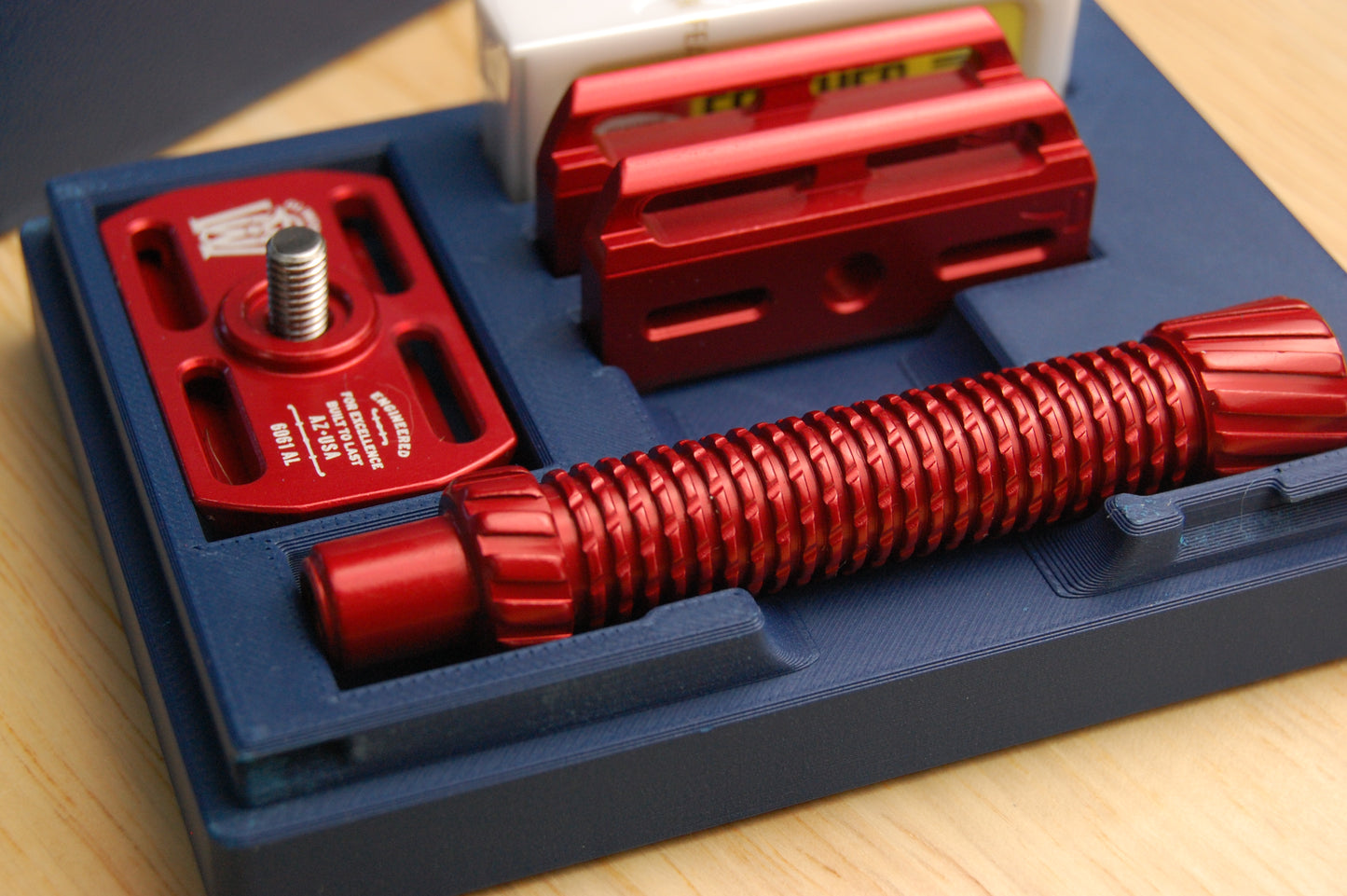 Close up of a Red Oliworks M3teorite in a Navy Blue travel case.