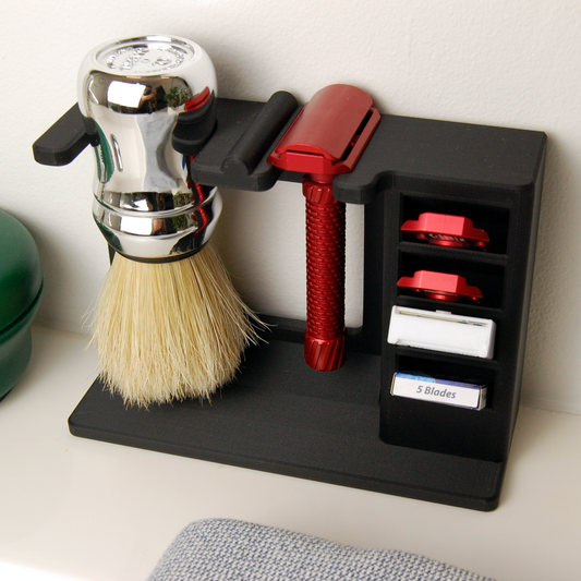 Shaving brush, stand, and razor with blades on a white background