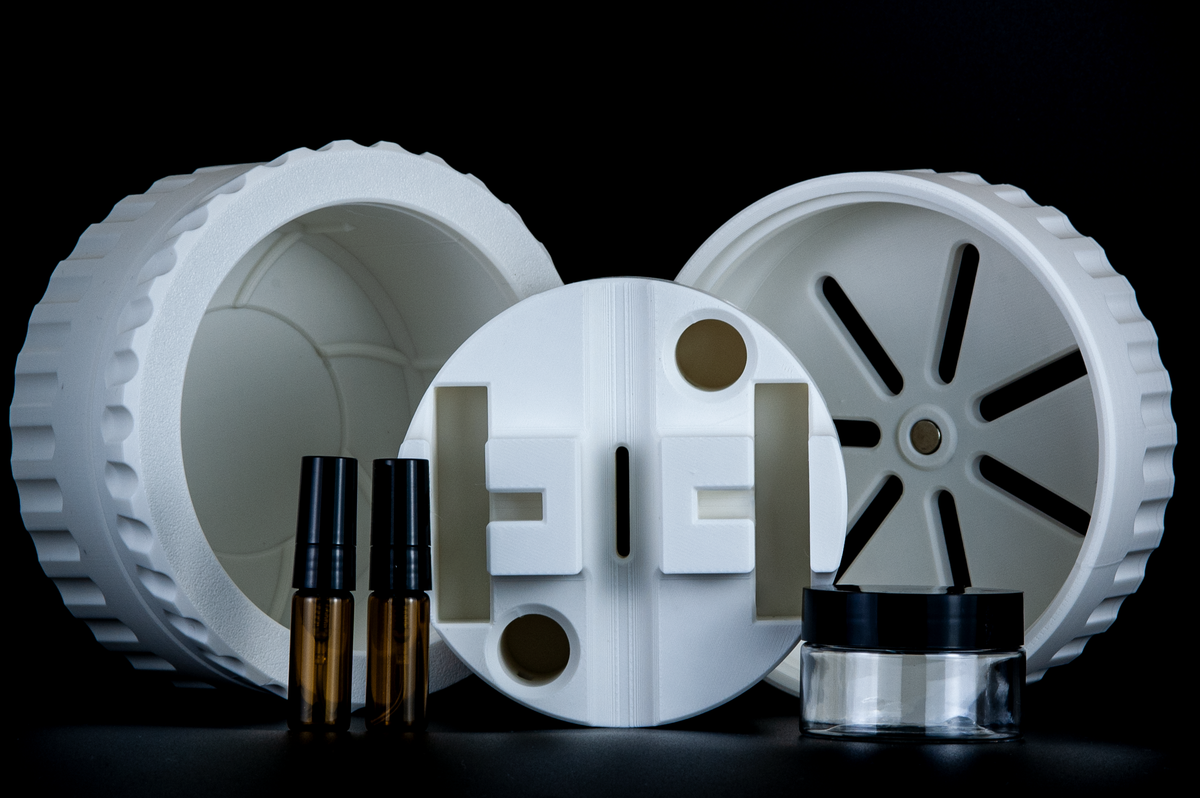 UFO Travel Shaving System, white cylindrical case with ridged shells, internal compartment, two amber roller bottles, small glass jar