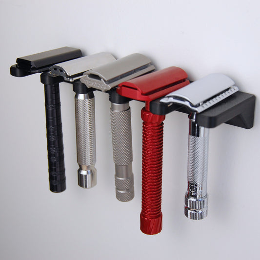5 slot razor garden wall mount on white wall with 5 razors displayed.