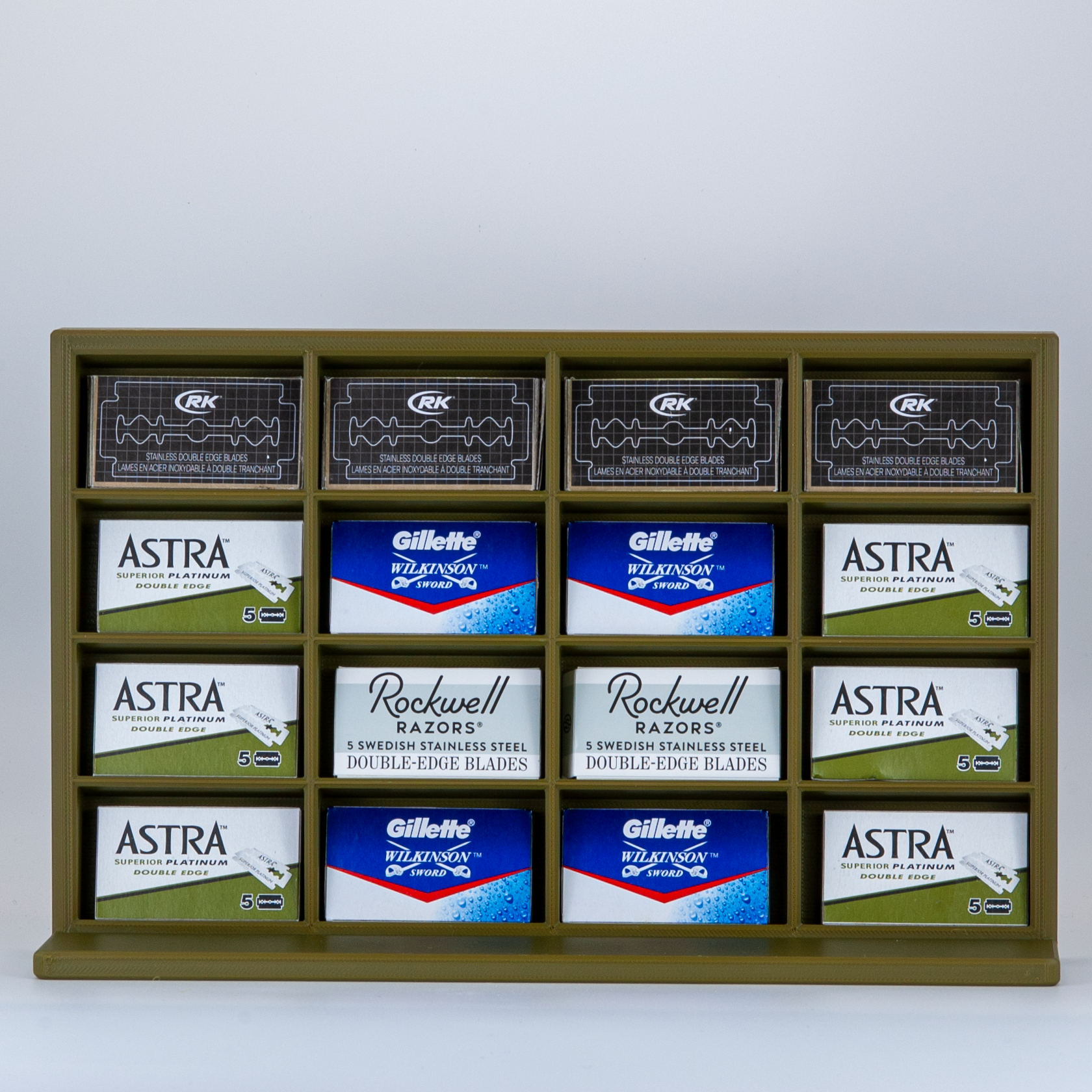 Army green razor blade stand on white background with Astra, Rockwell, RK, and Gillette Wilkinson blades displayed