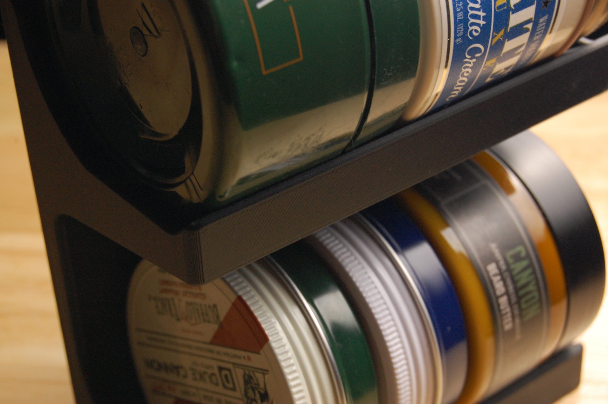 A collection of beard balms and butters in a storage stand.