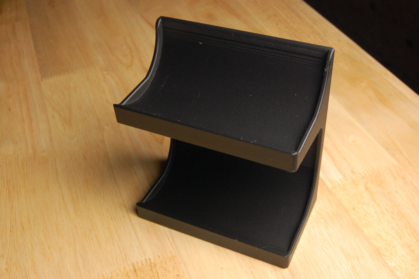 Black beard butter and pomade stand on a wooden surface
