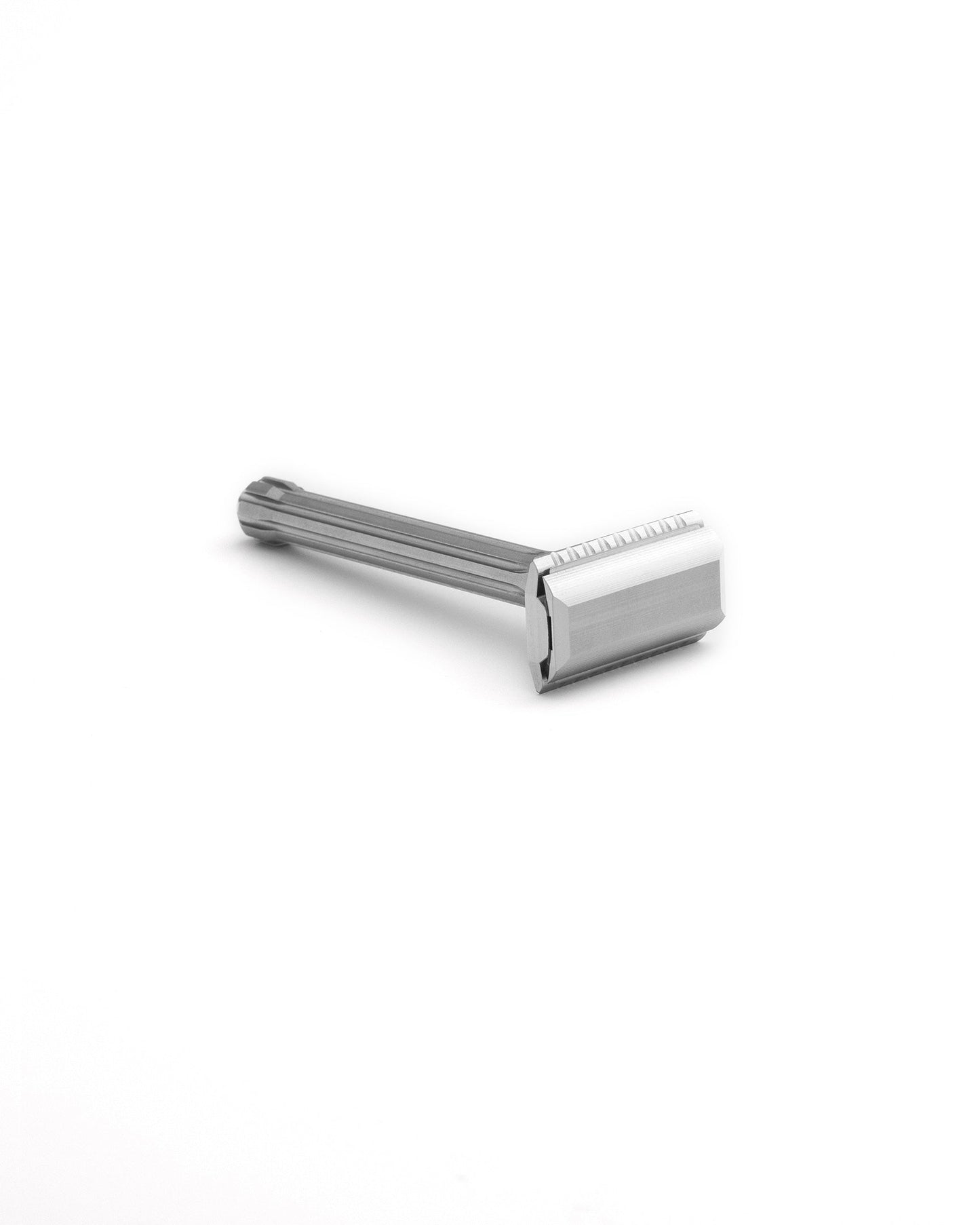 Blackbird double-edge safety razor in polished stainless steel with ridged handle, lying on white background