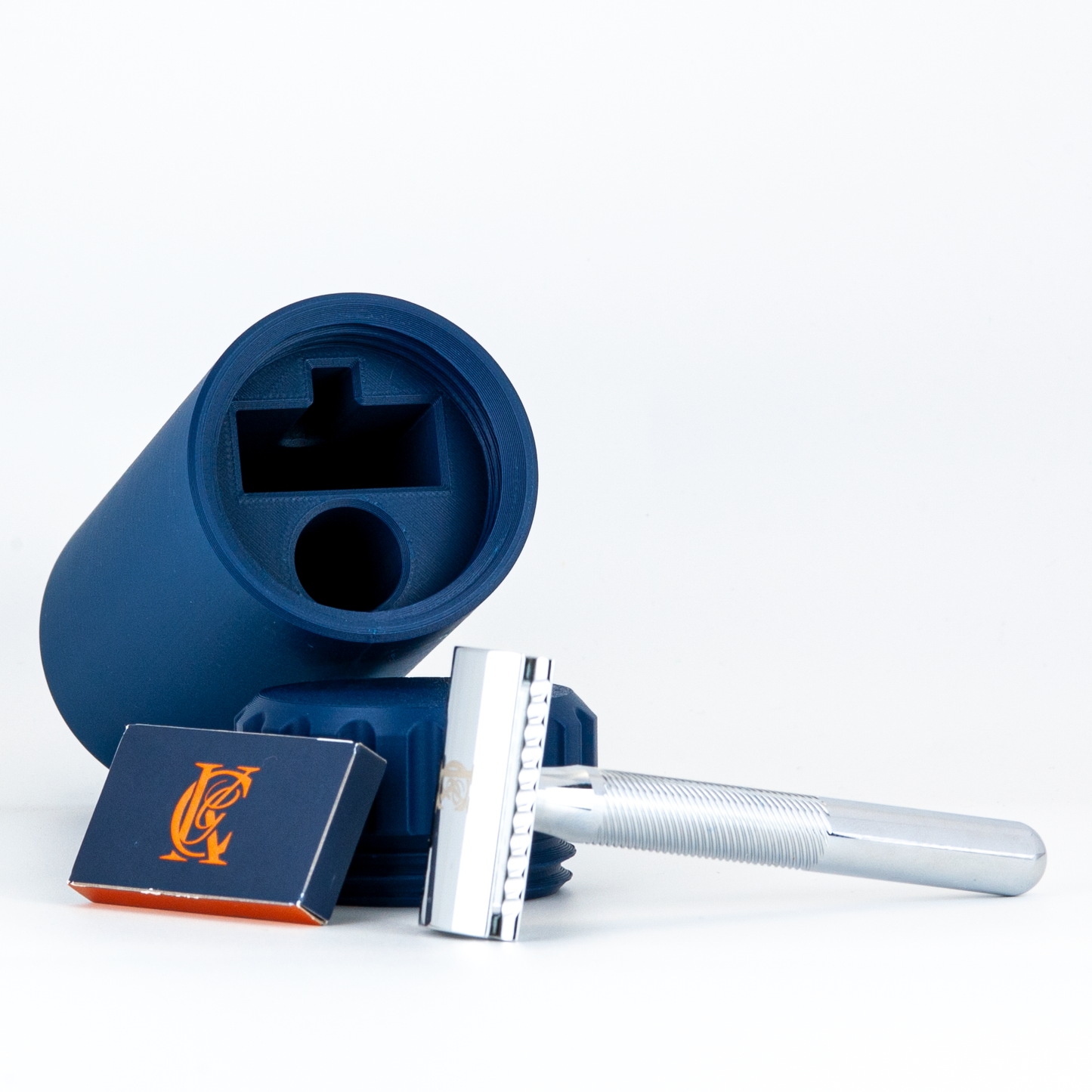 Blue Suborbital Capsule laying down with KC Razor and blades on a white background