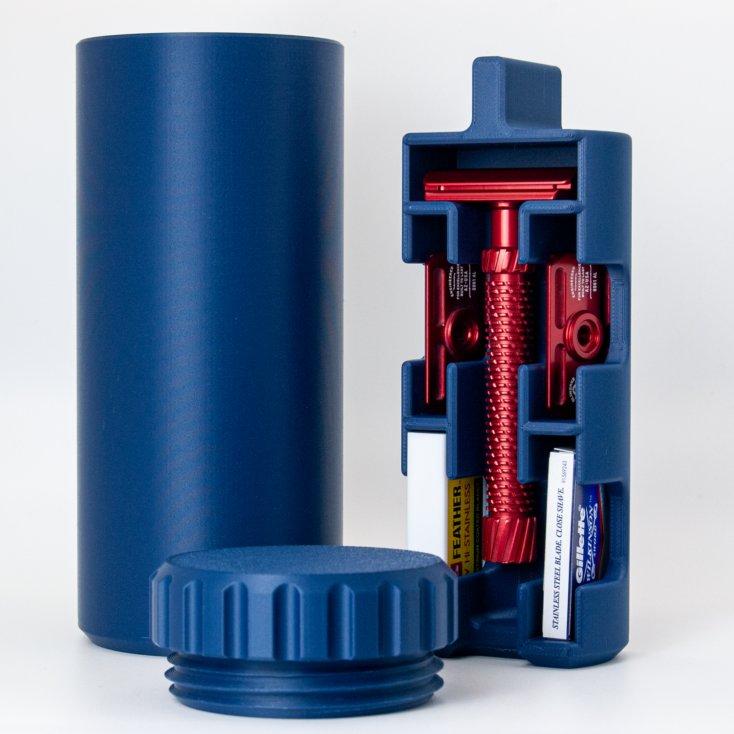 Navy Blue Capsule razor travel case on a white background with a red razor.