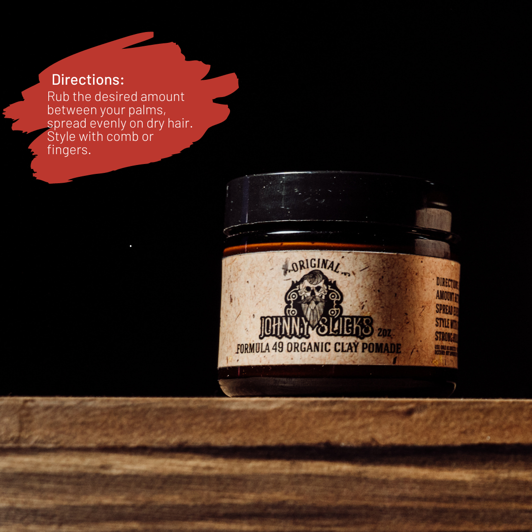 Johnny Slicks Formula 49 Organic Clay Pomade 2oz jar with black lid on wooden surface, directions text overlay