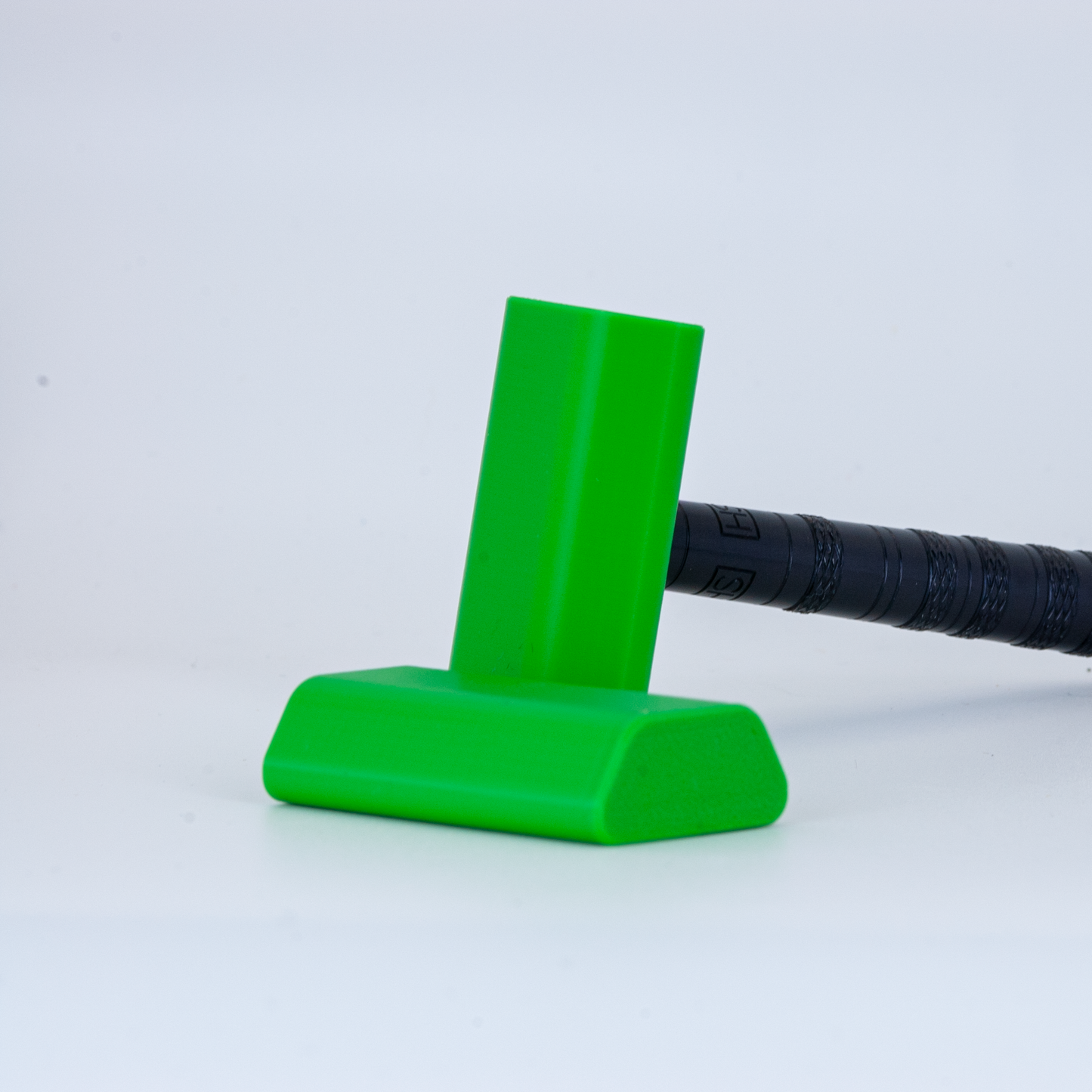 Green Henson cover on a black henson razor on a white background