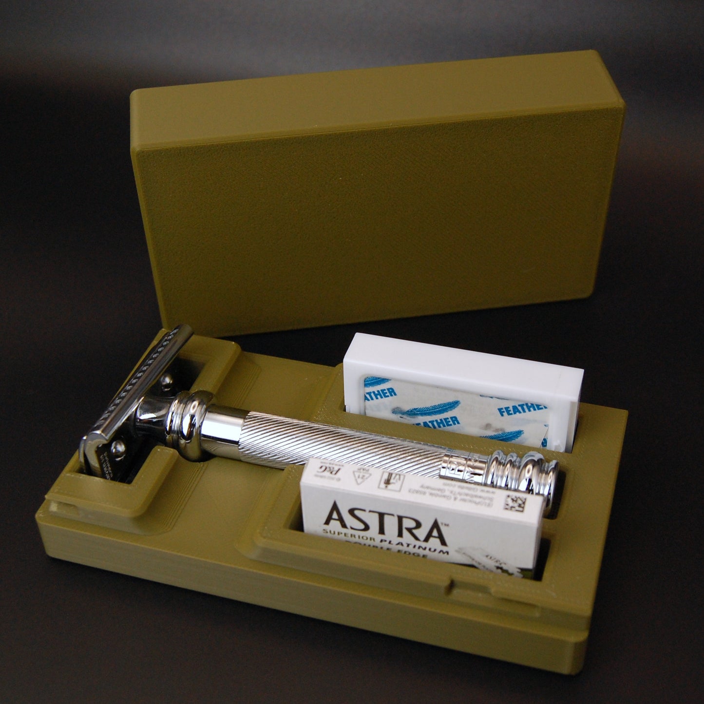 Army Green Merkur 39C razor travel case on a black background.