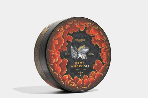 Decorative shave soap container with 'Eros Ambrosia' branding on a white background