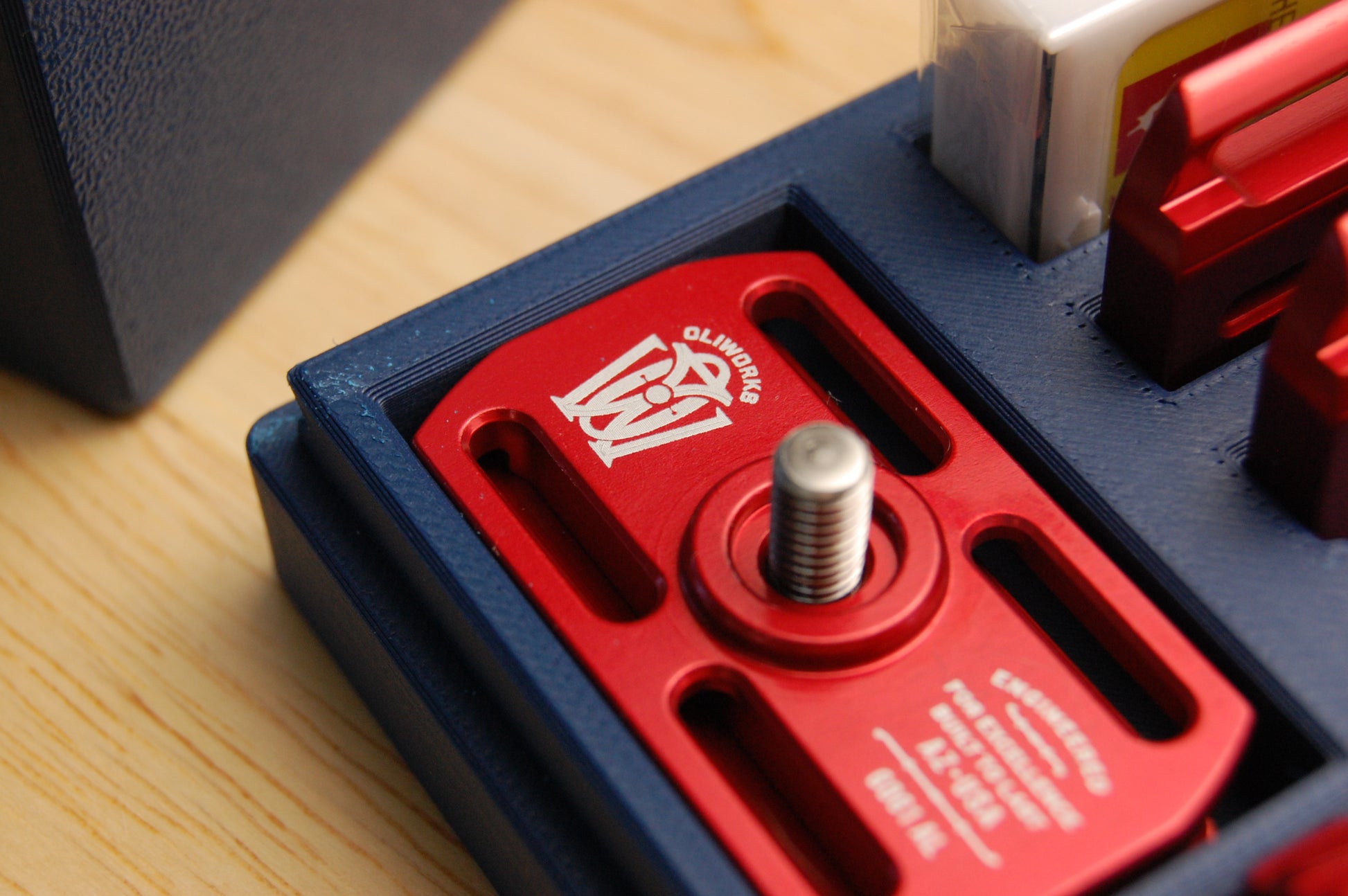 Close up of a Red Oliworks M3teorite in a Navy Blue travel case.  