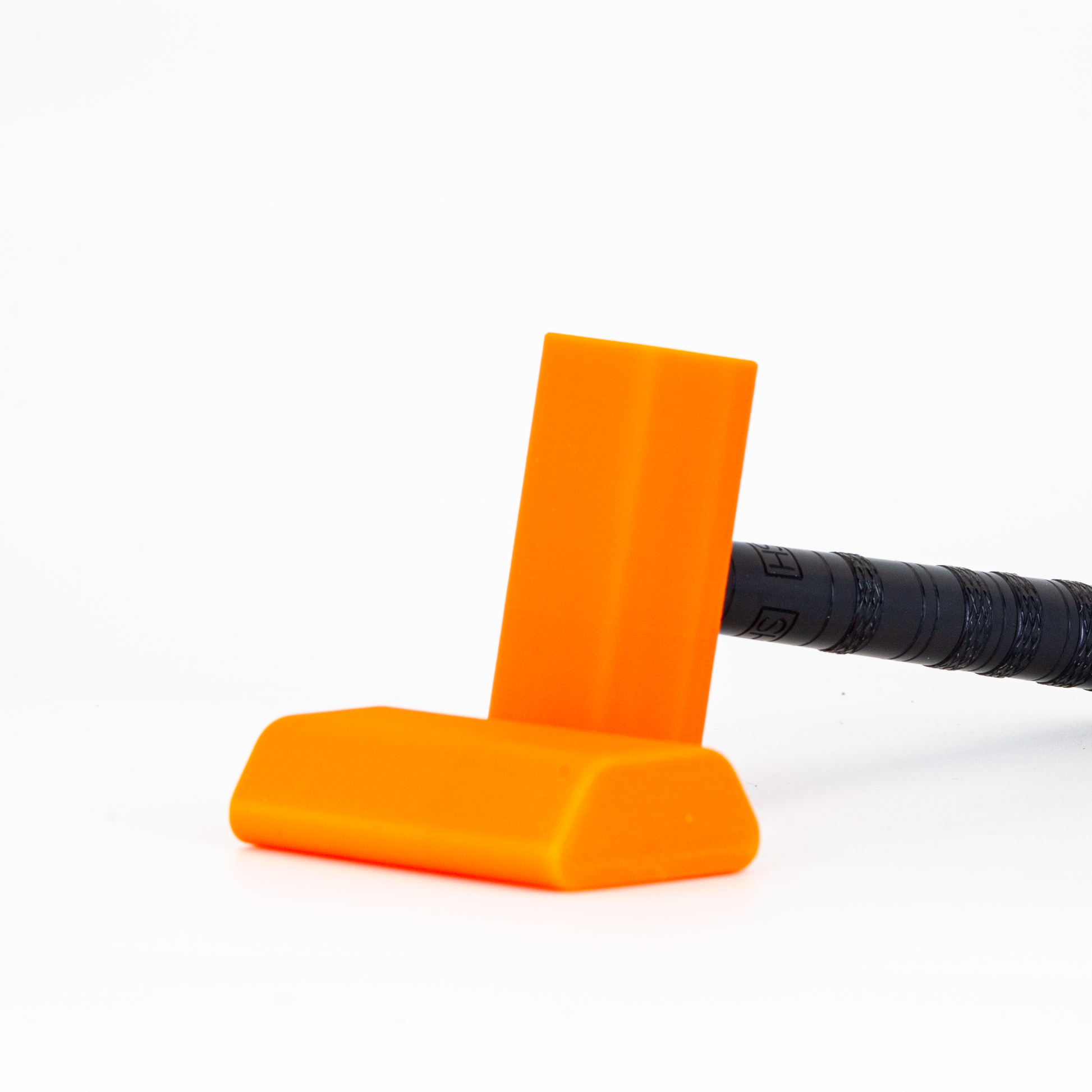 Orange Henson cover on a black henson razor on a white background