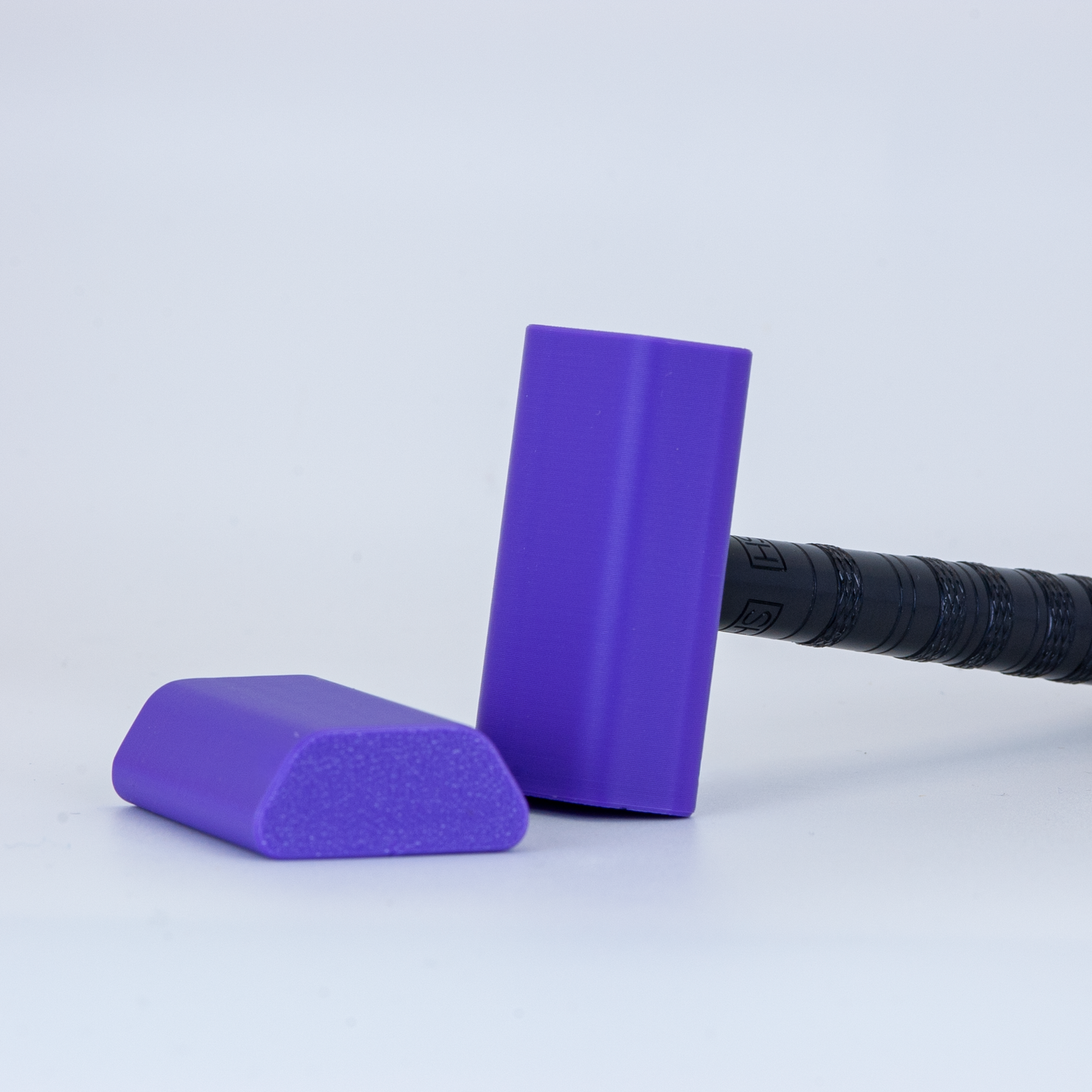 Purple Henson cover on a black henson razor on a white background