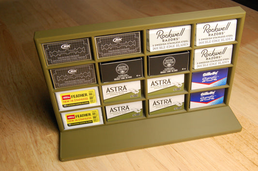 Display of various razor blade boxes on a wooden surface