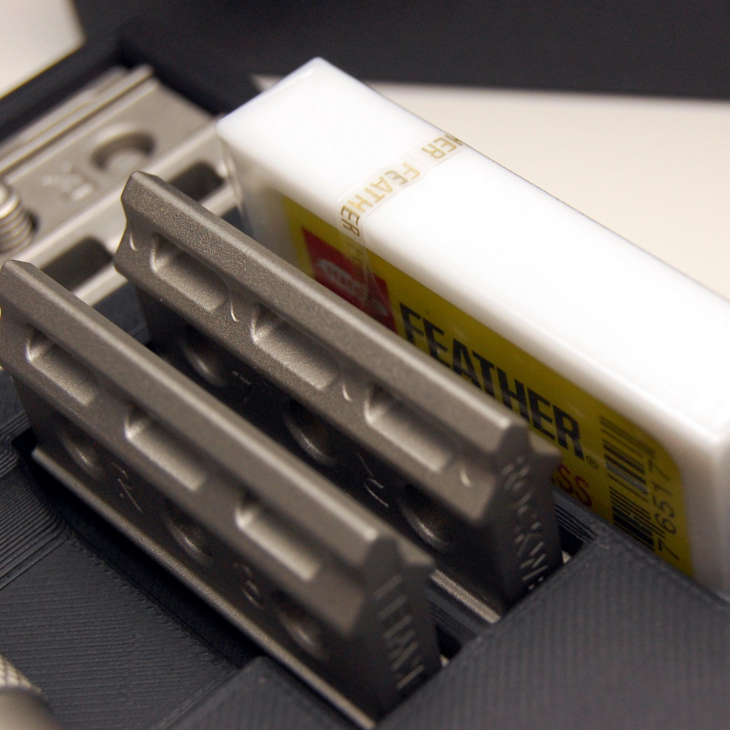 Closeup photo of the Rockwell Travel Case showcases that the case accommodates large 10-pack razor black boxes such as the Feather razor blades with their large plastic case.