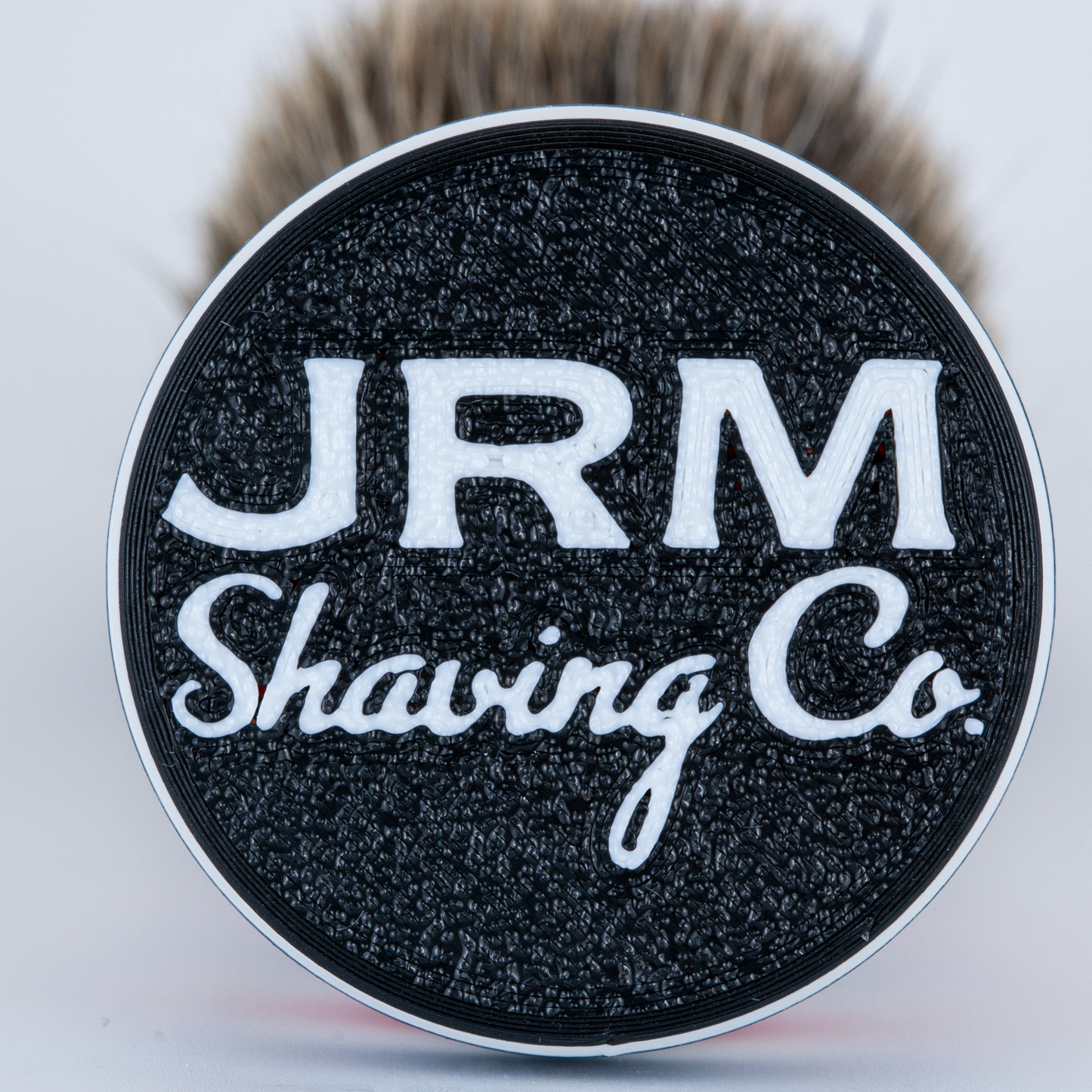 Shaving brush with JRM Shaving Co logo on a white background