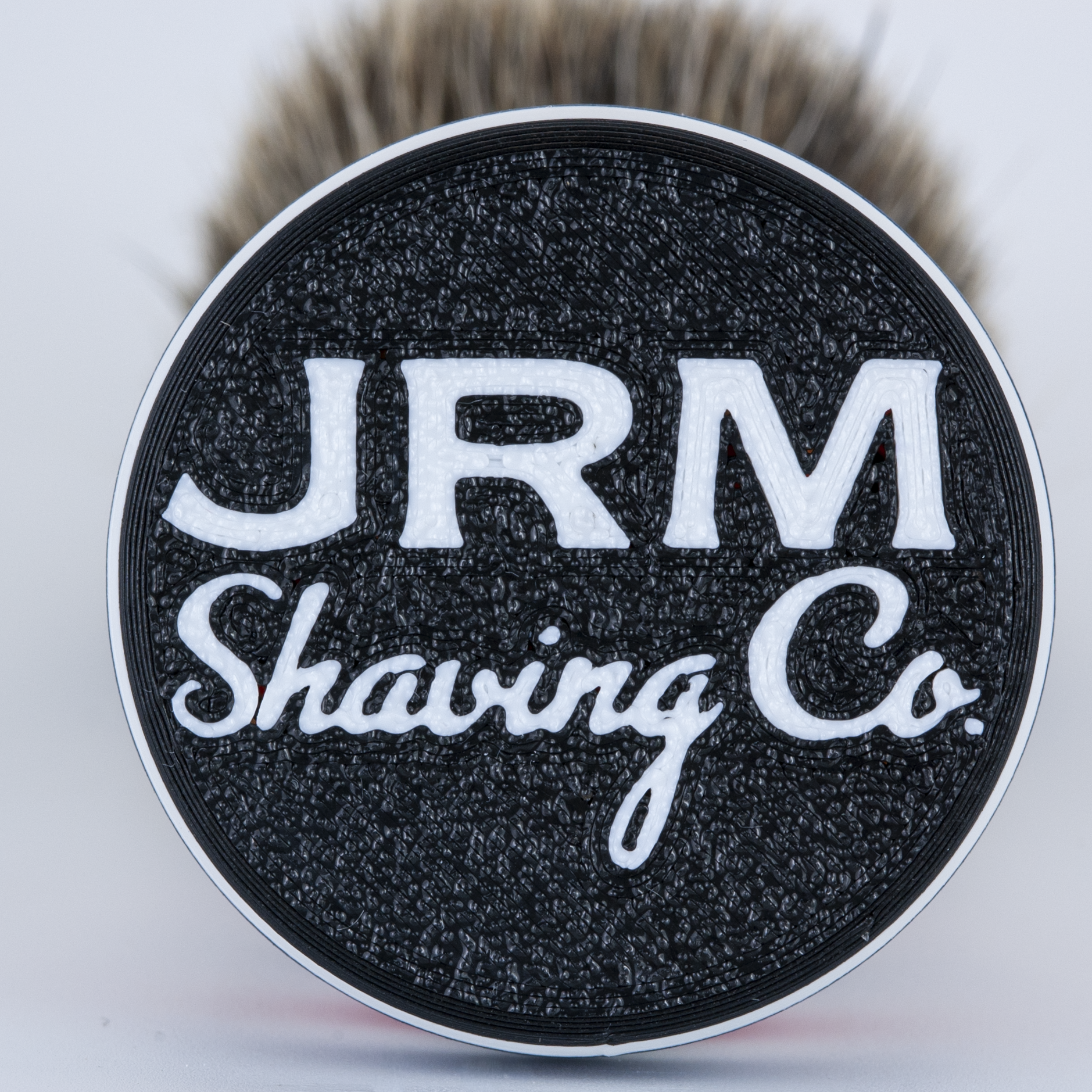 Shaving brush with JRM Shaving Co logo on a white background