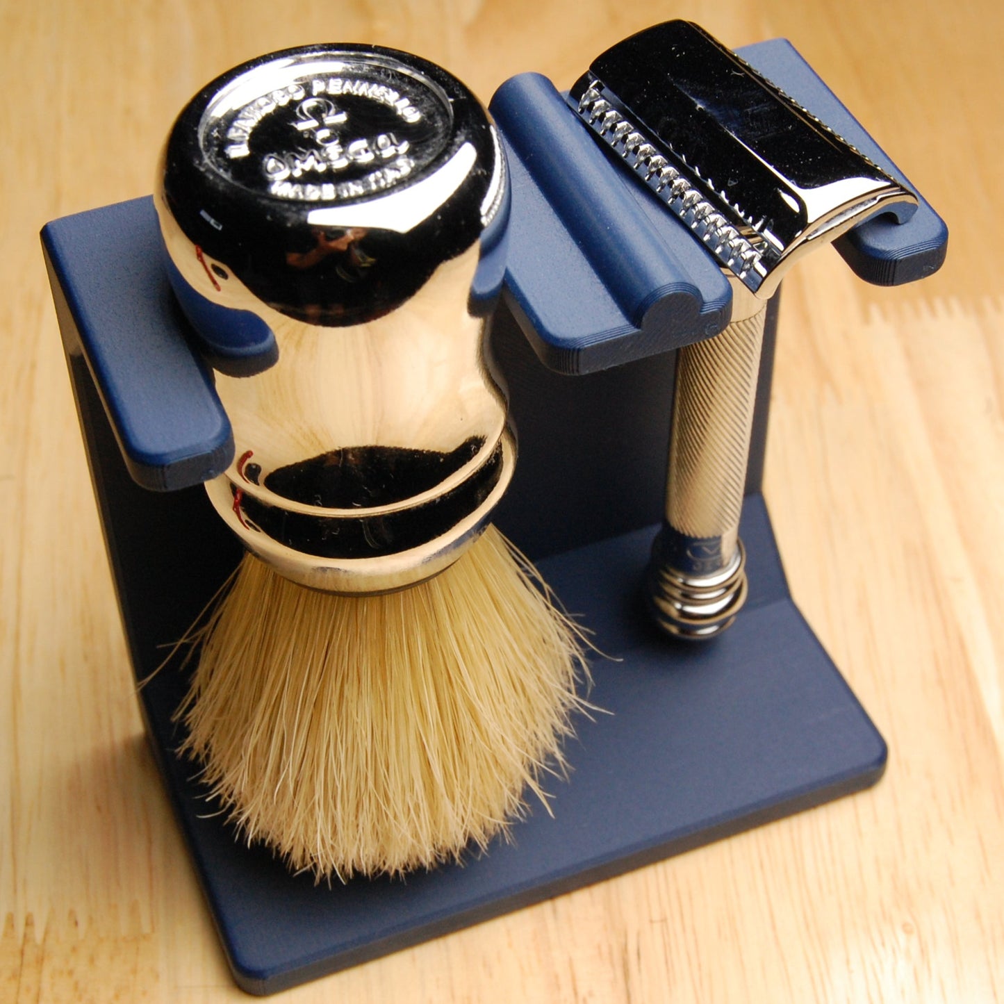 Shaving brush and razor on a stand with a wooden background