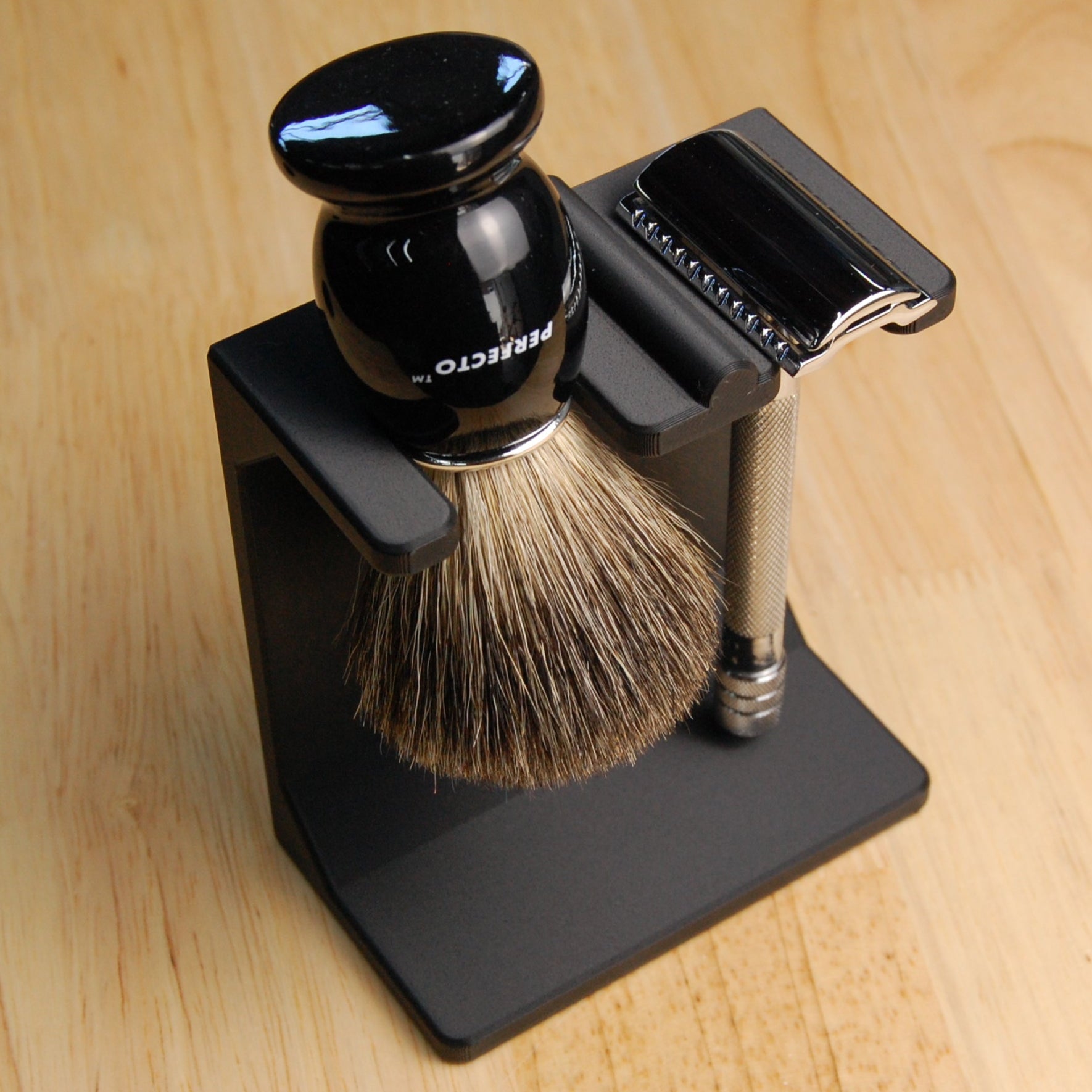 Shaving brush and razor on a stand with a wooden background