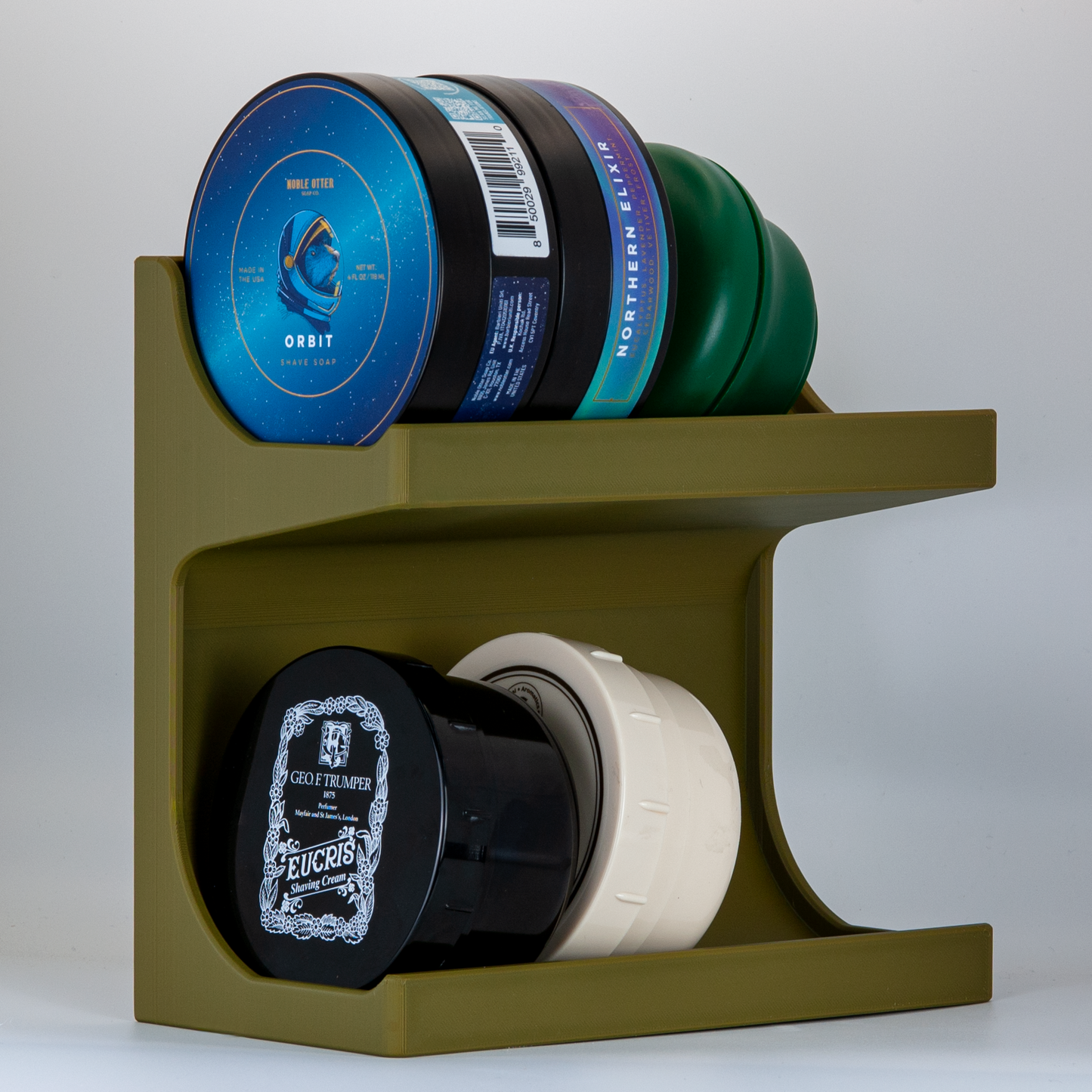 Army green soap stand on a white background with a collection Noble Otter and other shave soaps.