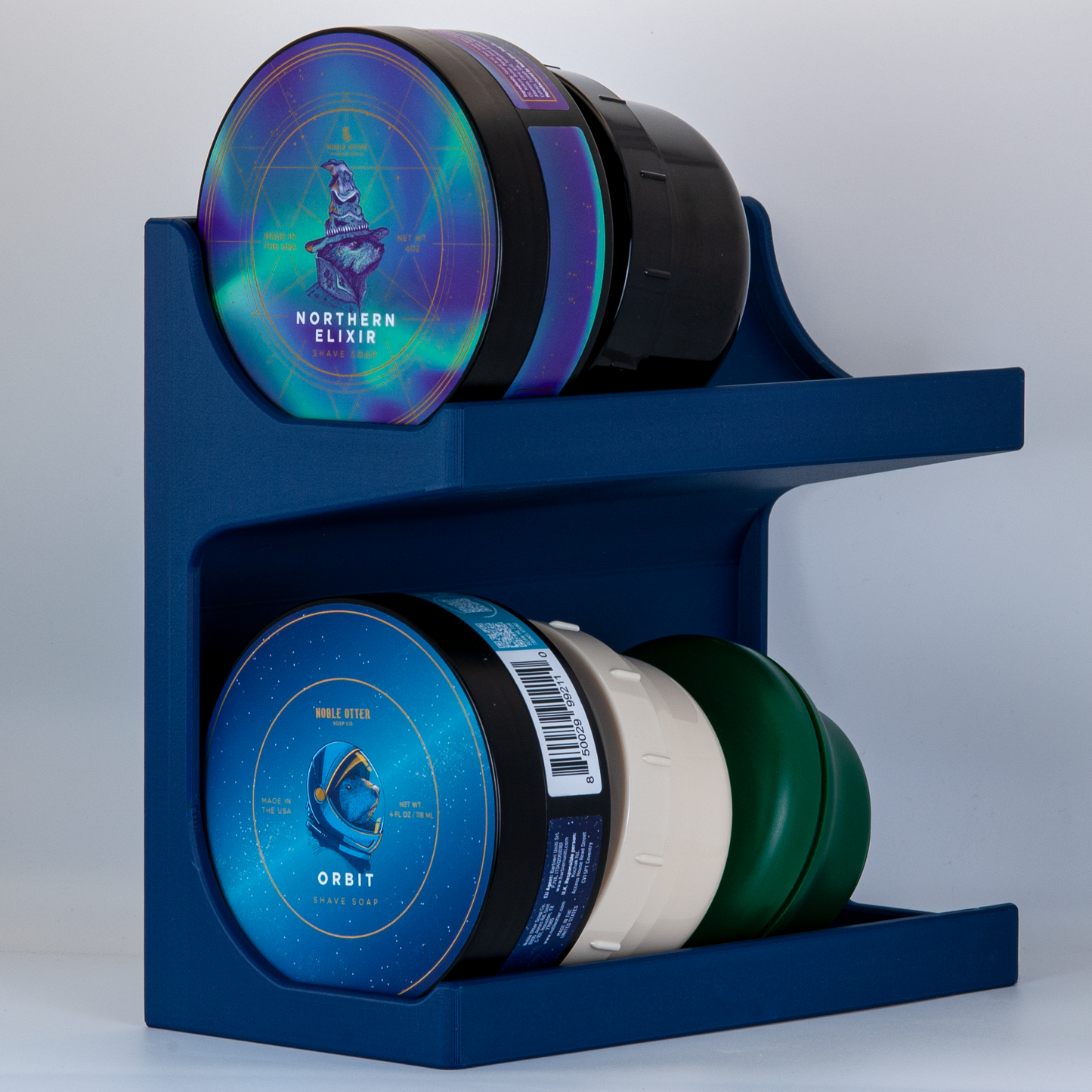 Navy Blue soap stand with Noble Otter and other soaps on a white background