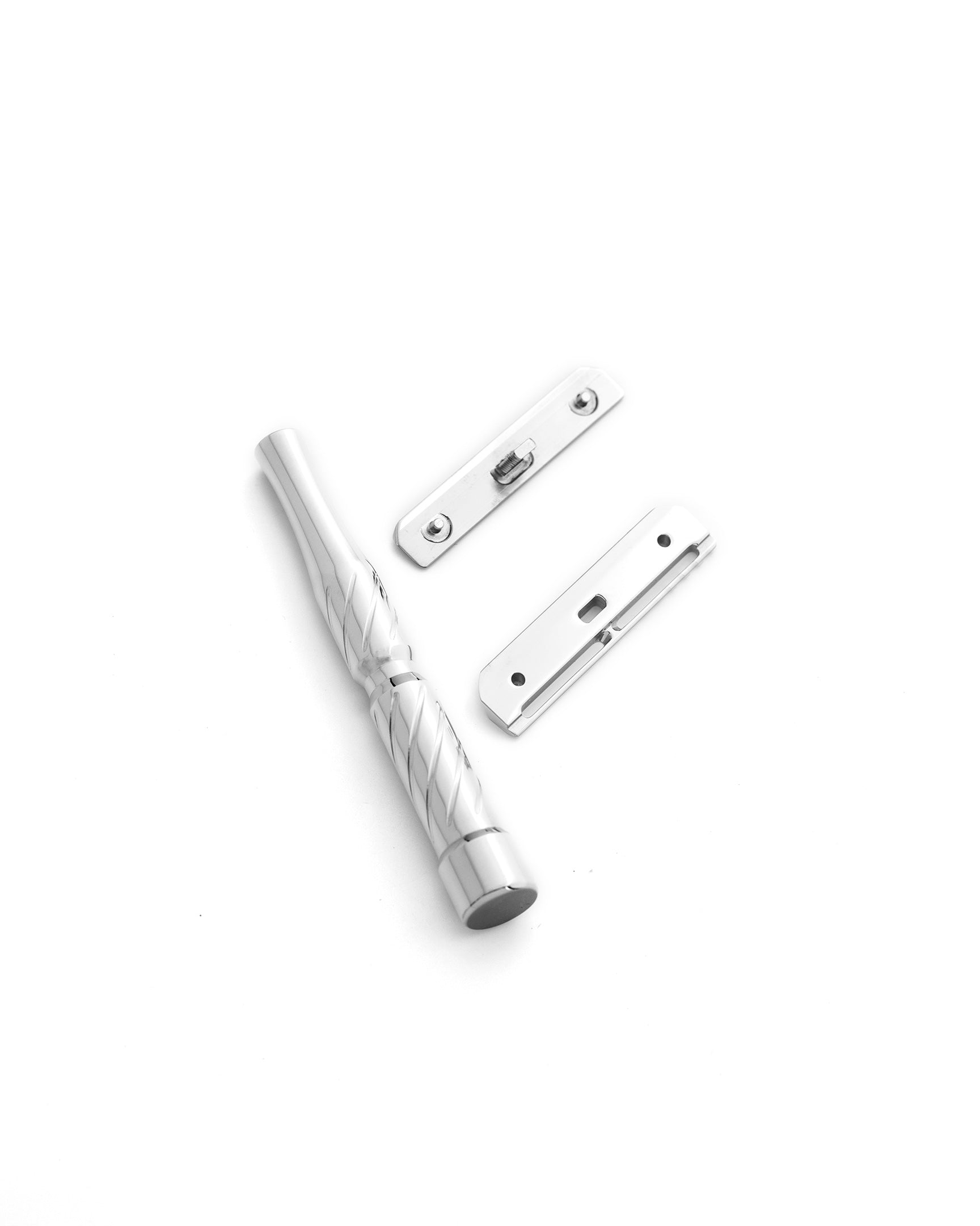 Disassembled stainless steel Vector safety razor with twisted handle, top cap, and base plate in polished chrome finish