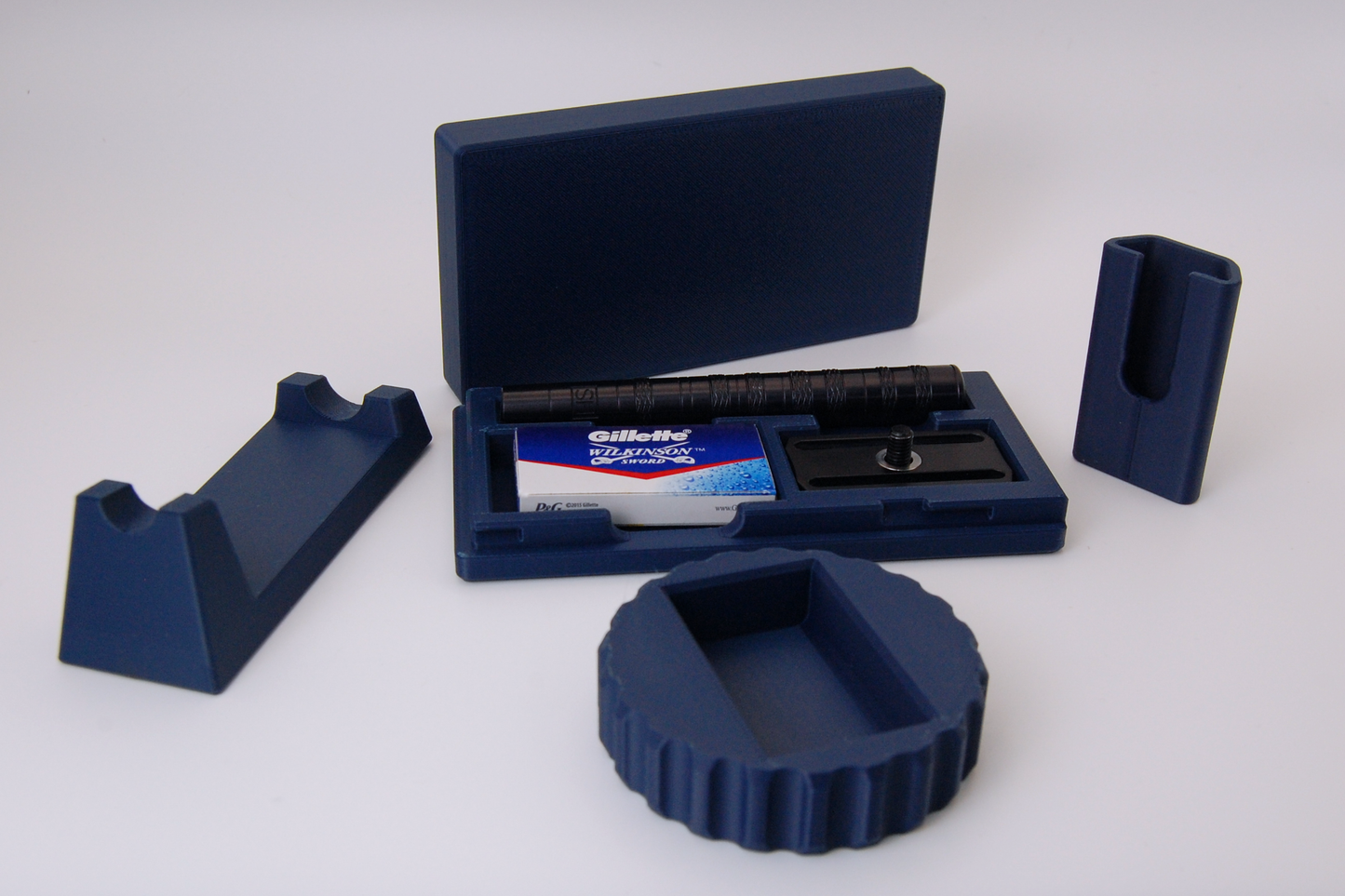 Henson razor bundle in navy blue on a white background.  Includes Henson Case, Henson Cover, razor stand, razor refueler.