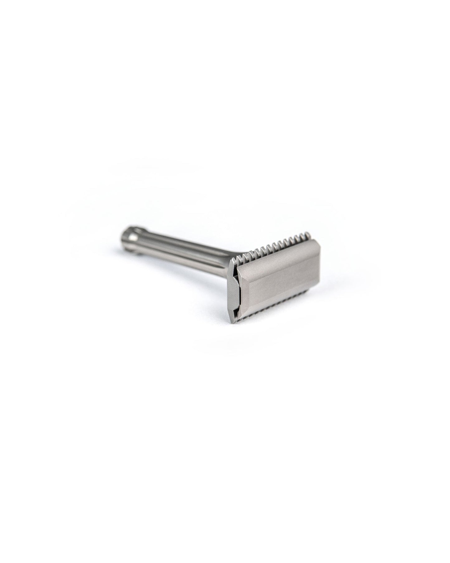 Blackbird Titanium double-edge safety razor with matte silver finish, short ribbed handle, and open-comb head