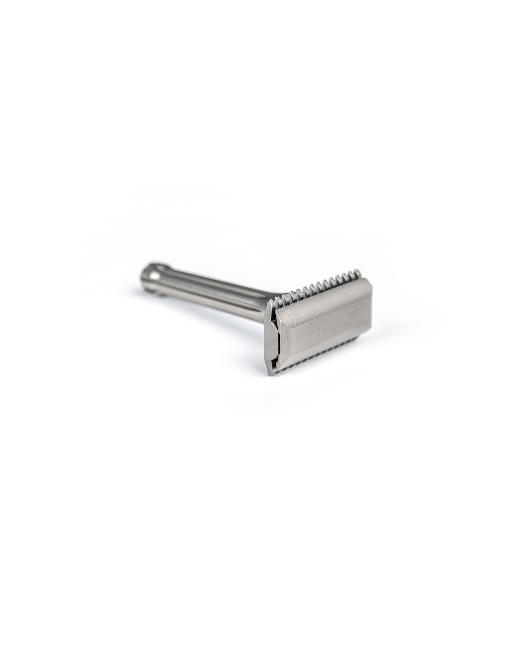 Blackbird Titanium double-edge safety razor with matte silver finish, short ribbed handle, and open-comb head