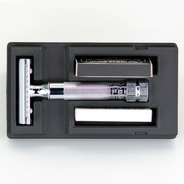 Open Merkur 34C safety razor travel case with chrome butterfly-style razor handle, box of Astra blades, and chrome baseplate