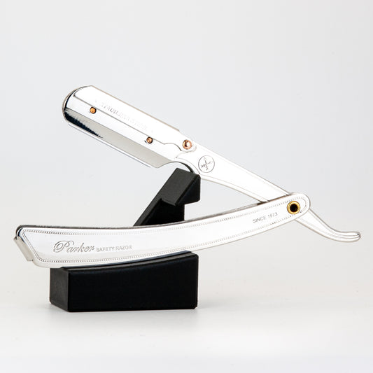 Parker straight razor resting open on The Launch Pad black stand, on a white background