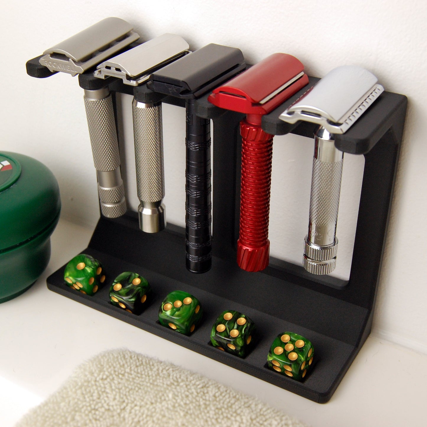 razor garden display stand on a white counter top.  green dice are in the dice slots.