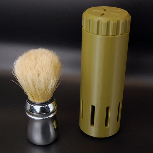 Army Green vented shaving brush travel case on a black background with a brush sitting next to it.